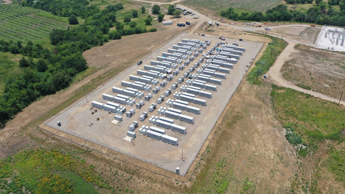 Aerial view of a rural battery storage facility surrounded by fields