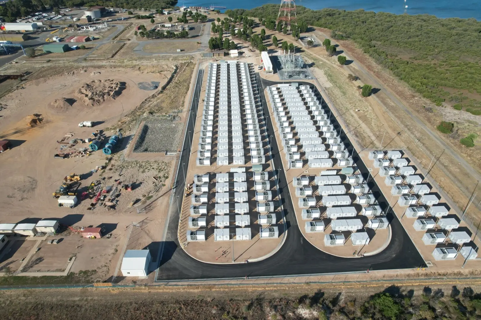 Aerial view of a large battery storage yard near the coast